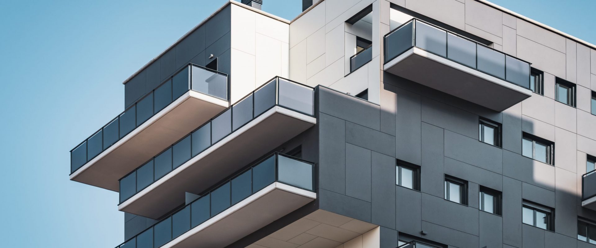 Geometric facades of a residential building full of balconies and windows