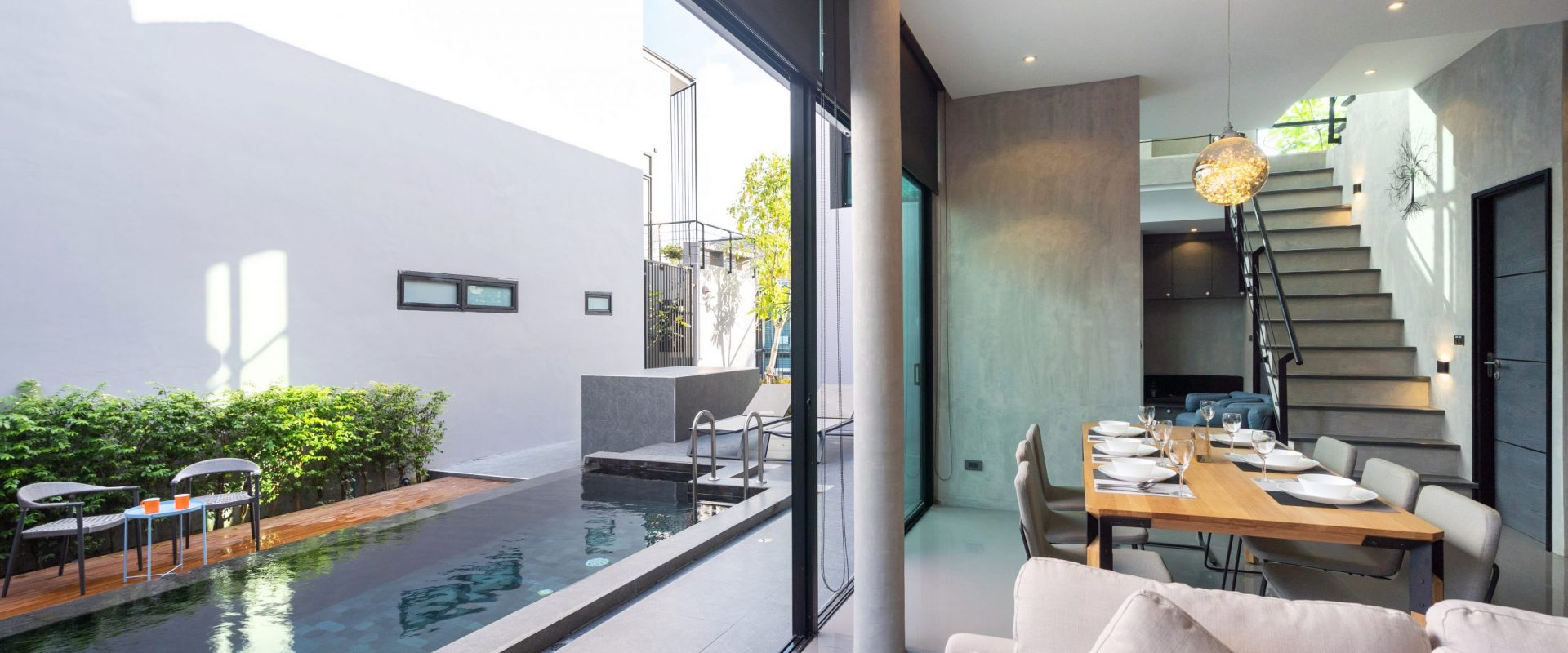 dining table in loft design and open space to pool access